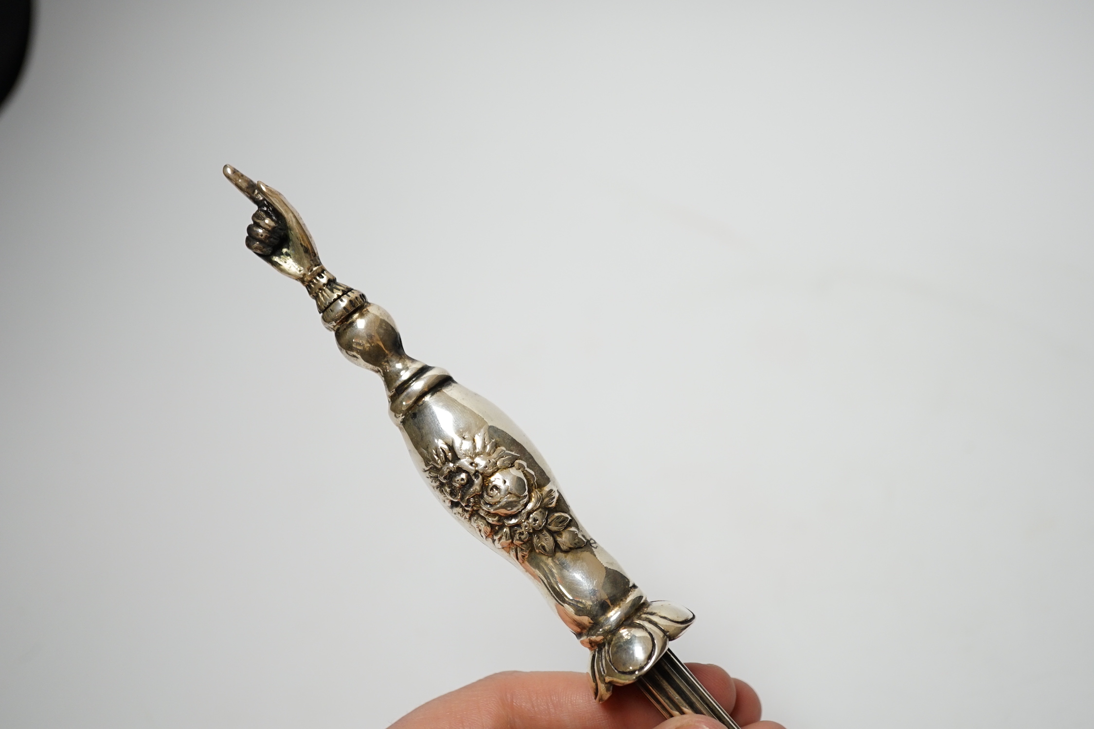 A late 19th century Russian 84 zolotnik torah pointer, with lion finial, 21.5cm and a plated example.